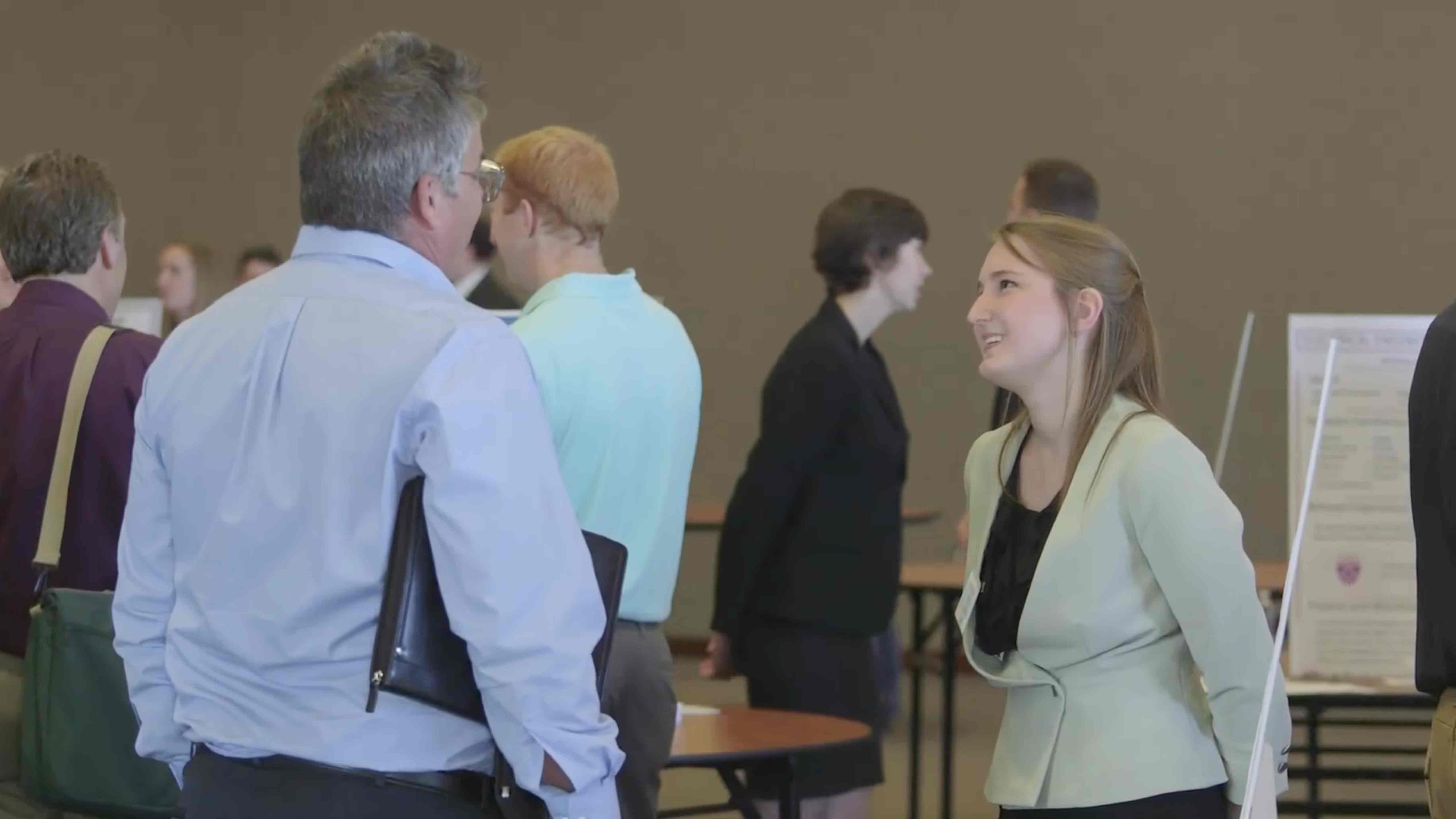 Student talks with an employer during Meet the Engineers