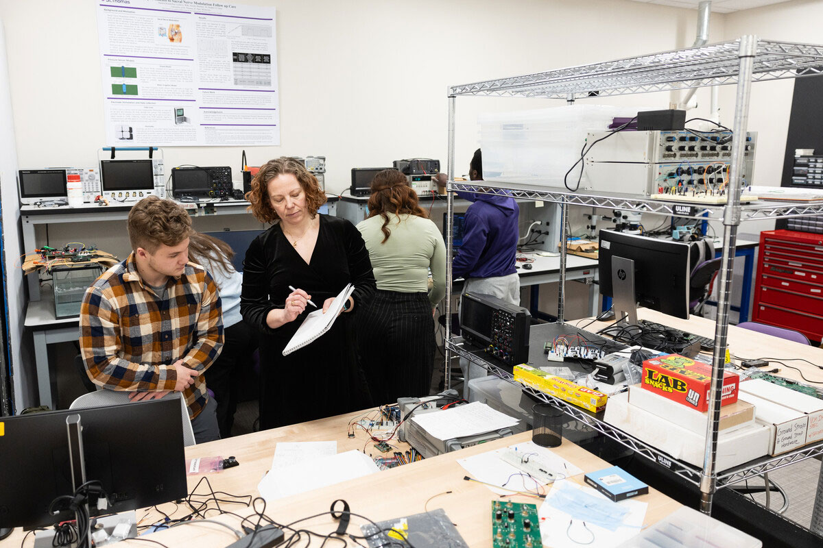 Engineering students and faculty discuss a project.